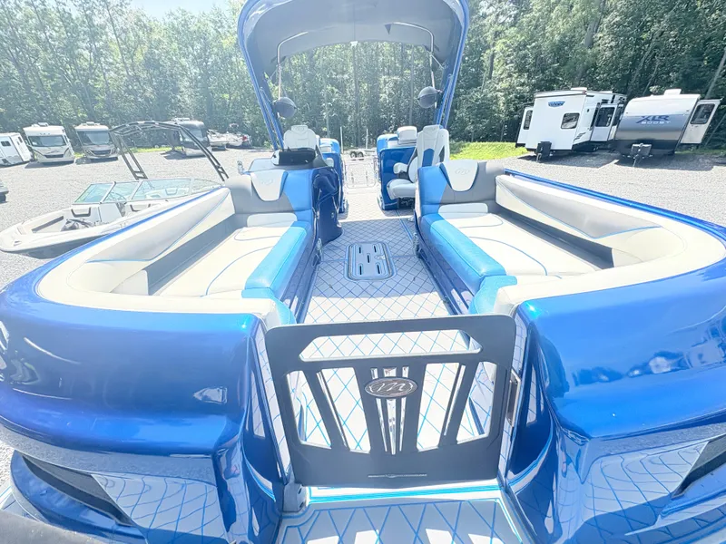 Slide: The Image of 2017 Manitou X-Plode Series 25 XT SRS SHP pontoon boat with blue and white interior. - 15