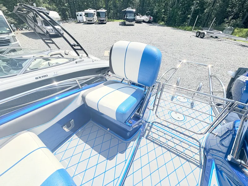 Slide: The Image of 2017 Manitou X-Plode Series 25 XT SRS SHP boat interior with blue and white seating. - 18