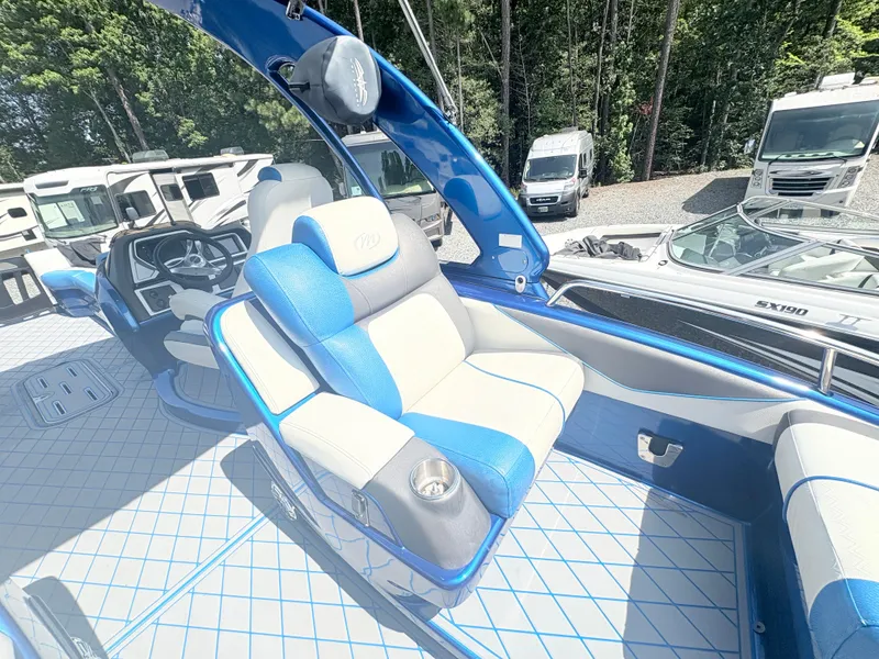 Slide: The Image of 2017 Manitou X-Plode Series 25 XT SRS SHP boat interior with blue and white seating. - 19