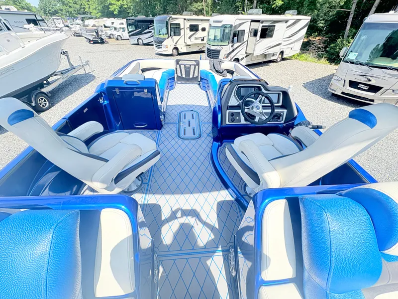 Slide: The Image of 2017 Manitou X-Plode Series 25 XT SRS SHP pontoon boat interior with blue and white seating. - 21