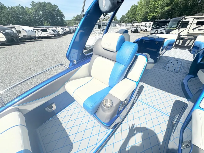 Slide: The Image of 2017 Manitou X-Plode Series 25 XT SRS SHP boat interior with blue and white seating. - 25