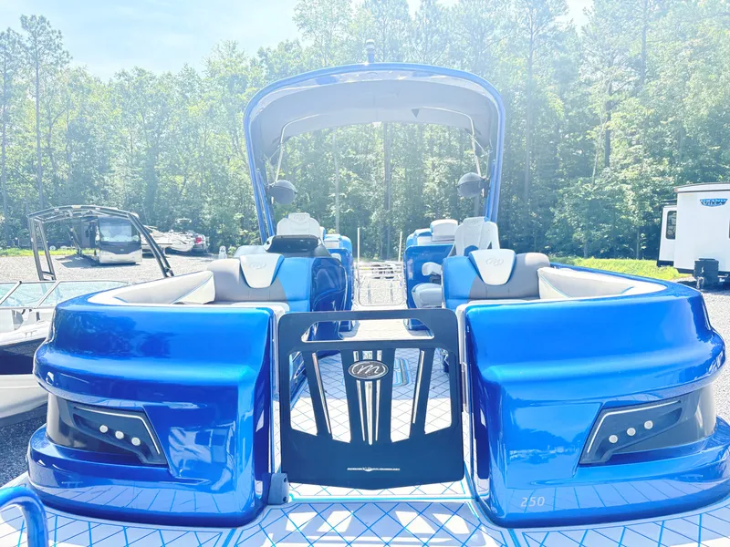 Slide: The Image of 2017 Manitou X-Plode Series 25 XT SRS SHP pontoon boat, vibrant blue, parked outdoors. - 7