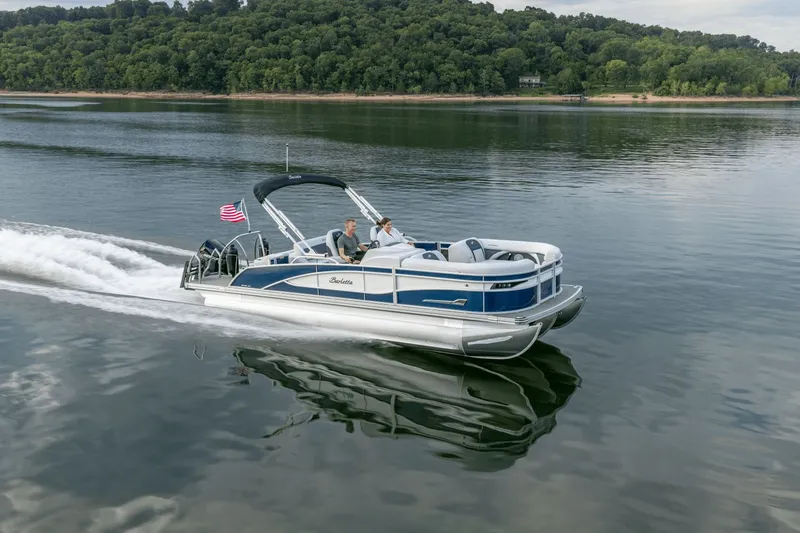The Image of 2026 Barletta CORSA 25 UC pontoon boat cruising on a serene lake. - 0