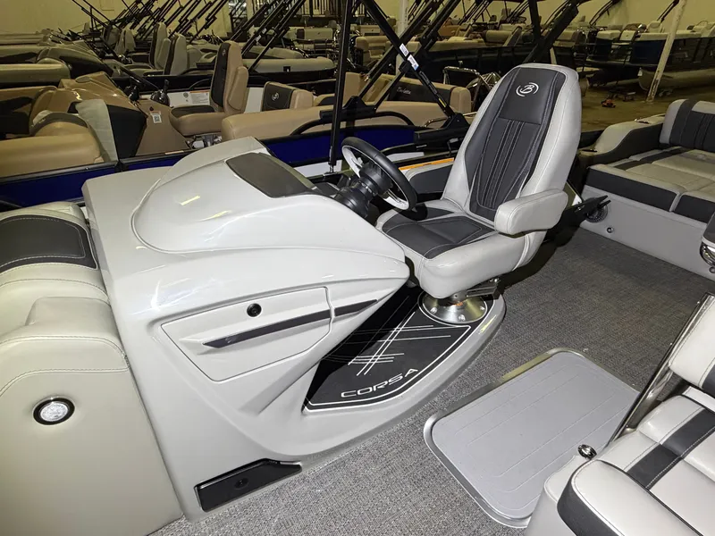 Slide: The Image of The image shows the helm of a 2026 Barletta Corsa 25 UE with a sleek gray seat. - 16