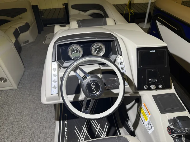 Slide: The Image of The image shows the helm of a 2026 Barletta Corsa 25 UE boat with modern instruments. - 20