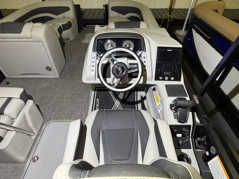 Slide: The Image of The image shows the cockpit of a 2026 Barletta Corsa 25 UE boat with modern instruments. - 19