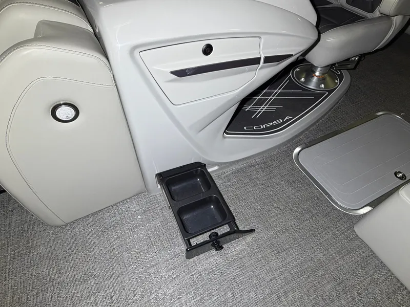 Slide: The Image of Interior of a Barletta Corsa 25 UE with gray carpet and a pull-out cup holder. - 18