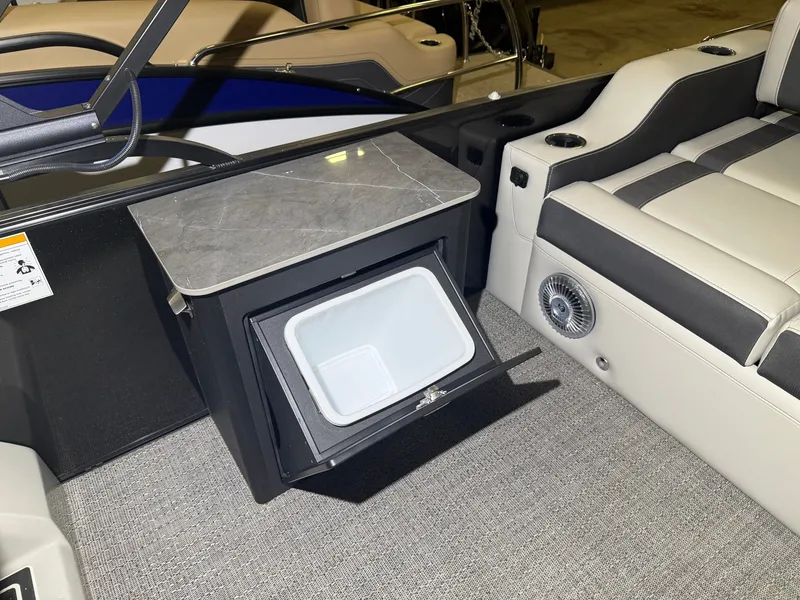 Slide: The Image of The image shows the interior of a 2026 Barletta Corsa 25 UE boat with a built-in cooler. - 24
