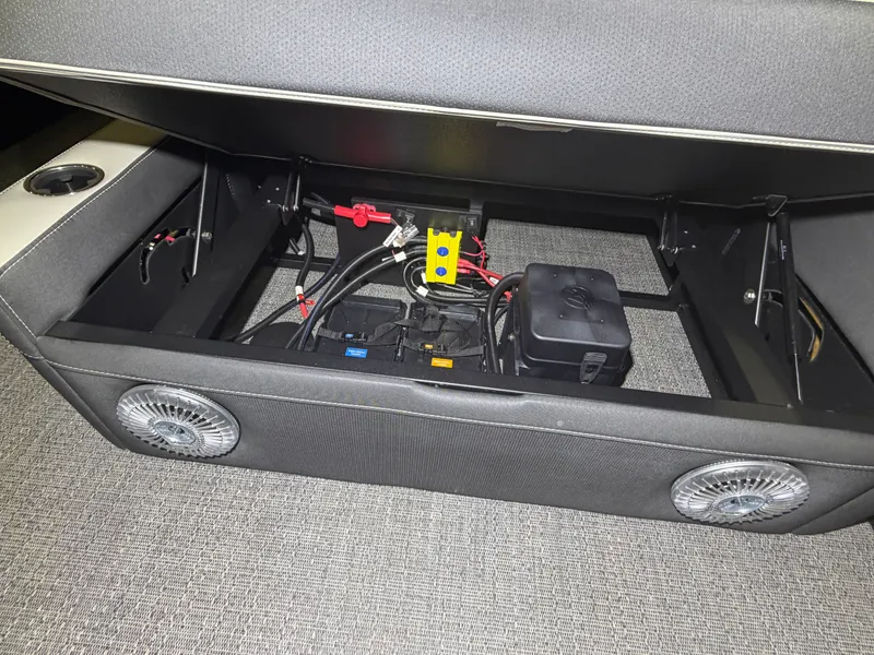 Slide: The Image of An open storage compartment in a Barletta Corsa 25 UE boat reveals wiring and electronics. - 28