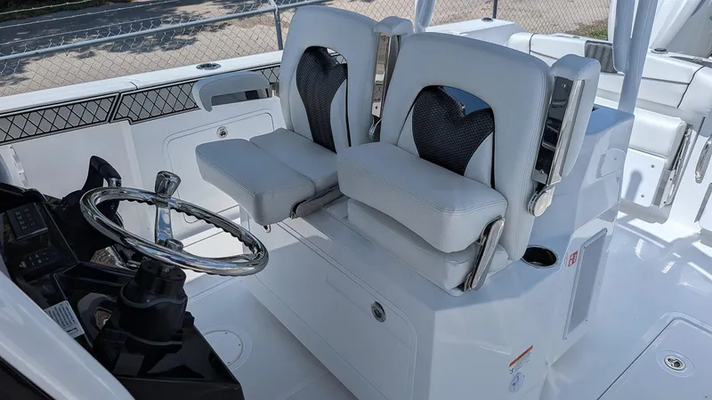 Slide: The Image of 2026 Wellcraft 302 Fisherman boat interior with dual helm seats and steering wheel. - 10