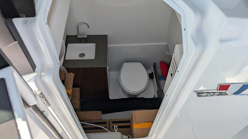 Slide: The Image of 2026 Wellcraft 302 Fisherman boat interior with sink and toilet. - 12