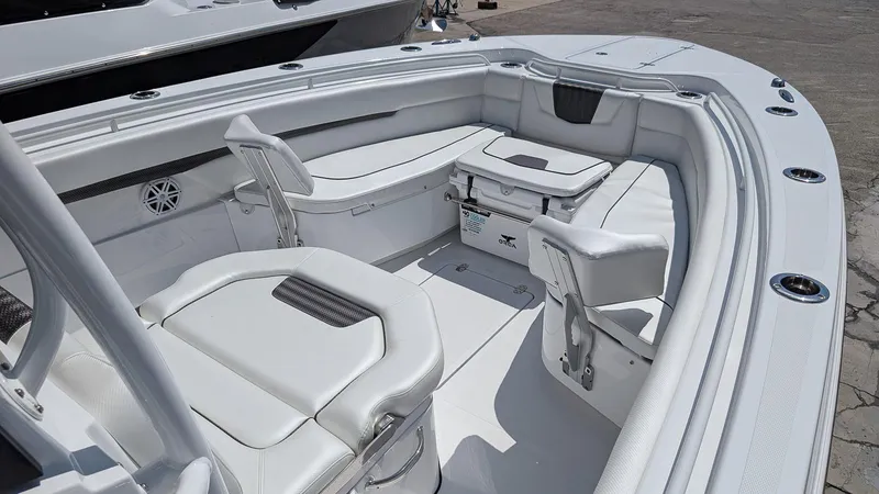 Slide: The Image of 2026 Wellcraft 302 Fisherman boat interior with white seating and storage. - 13