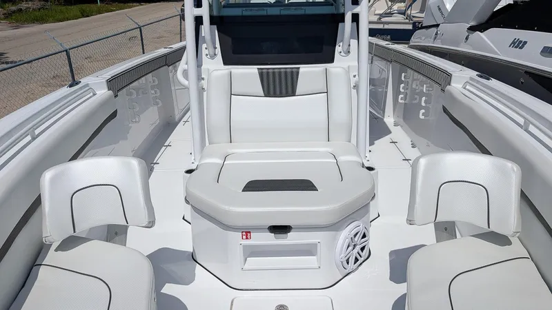 Slide: The Image of 2026 Wellcraft 302 Fisherman boat interior with white seating and modern design. - 14