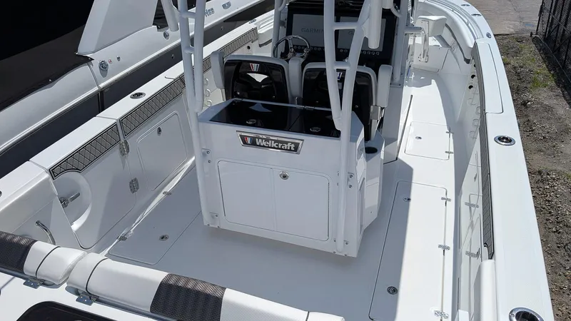 Slide: The Image of 2026 Wellcraft 302 Fisherman boat interior with helm and seating area. - 3