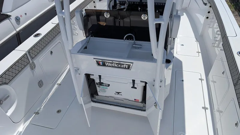 Slide: The Image of 2026 Wellcraft 302 Fisherman boat interior with storage and seating area. - 7