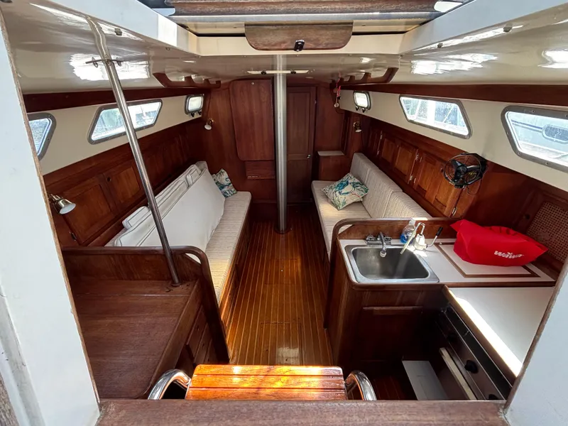 Slide: The Image of Interior of a 1988 Bristol 33.3 sailboat with wood finish and cozy seating. - 13