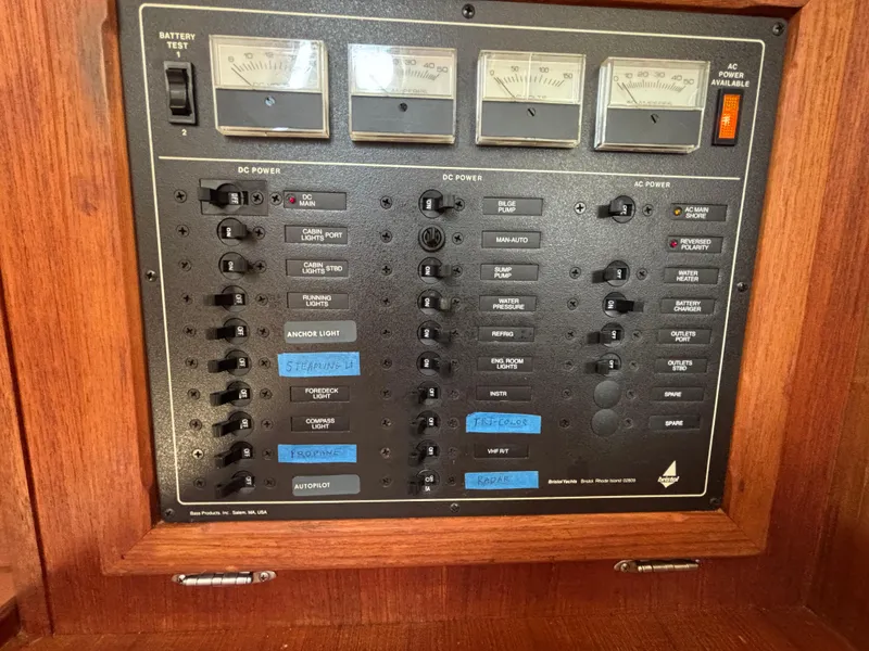 Slide: The Image of Electrical control panel on a 1988 Bristol 33.3 boat with labeled switches and meters. - 14