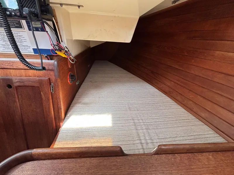 Slide: The Image of Interior cabin of 1988 Bristol 33.3 sailboat with wooden paneling and striped bedding. - 15