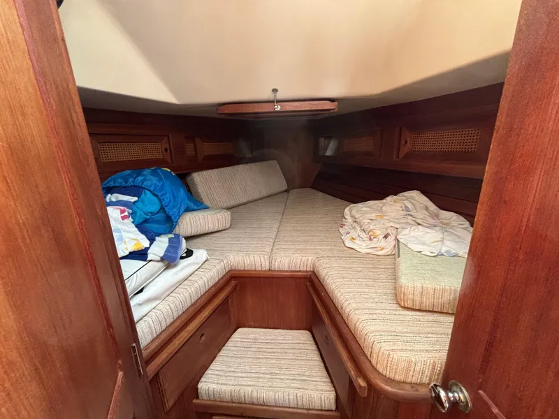 Slide: The Image of Cozy cabin interior of 1988 Bristol 33.3 sailboat with wooden finish and bedding. - 17