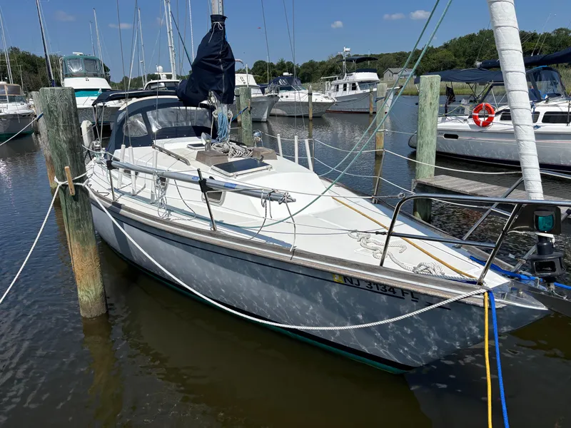 Slide: The Image of 1988 Bristol 33.3 sailboat docked in a marina, surrounded by other boats. - 2