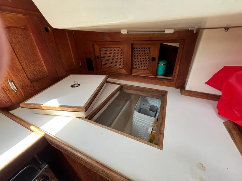 Slide: The Image of 1988 Bristol 33.3 yacht interior with wooden cabinetry and storage compartments. - 20