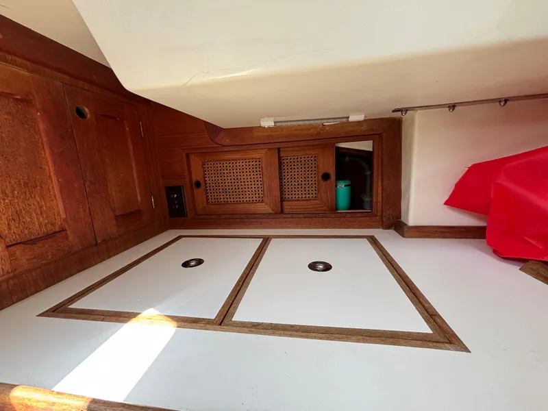 Slide: The Image of Interior of a 1988 Bristol 33.3 sailboat with wooden cabinetry and storage compartments. - 21