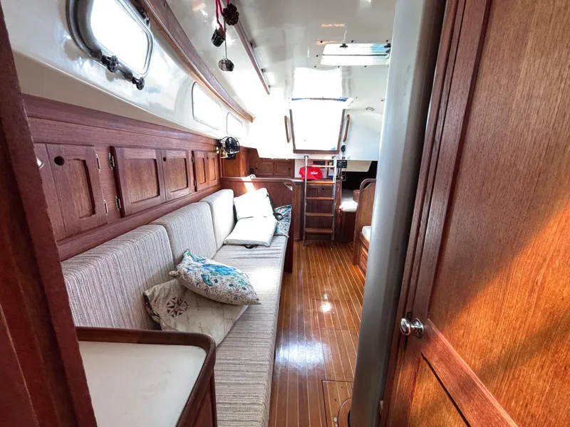 Slide: The Image of Interior of a 1988 Bristol 33.3 sailboat with wooden cabinetry and cushioned seating. - 24