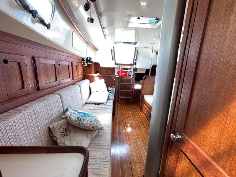 Slide: The Image of Interior of a 1988 Bristol 33.3 sailboat with wooden finishes and cozy seating. - 25