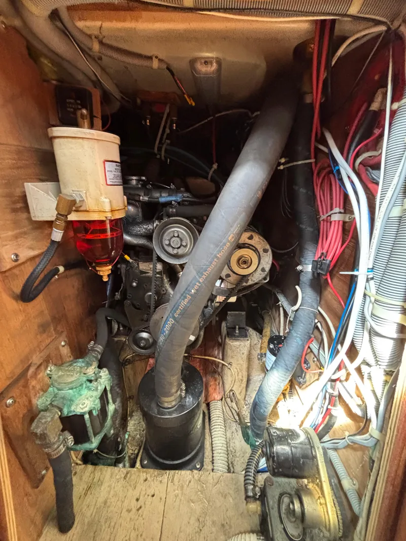 Slide: The Image of Engine compartment of a 1988 Bristol 33.3 sailboat, showing hoses and wiring. - 26