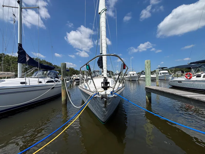 Slide: The Image of Sailboat docked at marina, Bristol 33.3, 1988 model, under clear blue sky. - 3