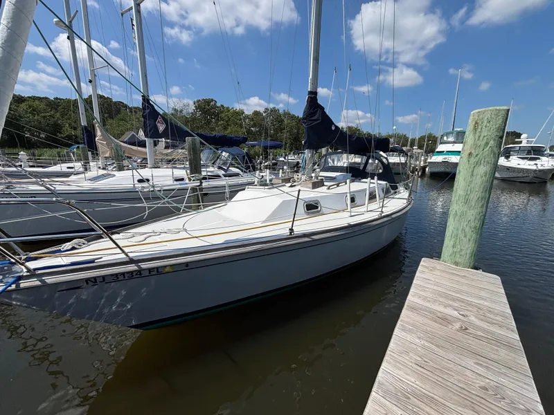 Slide: The Image of 1988 Bristol 33.3 sailboat docked at a marina under a clear blue sky. - 4