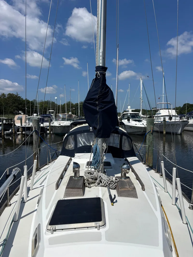 Slide: The Image of 1988 Bristol 33.3 sailboat docked at marina under clear blue sky. - 7