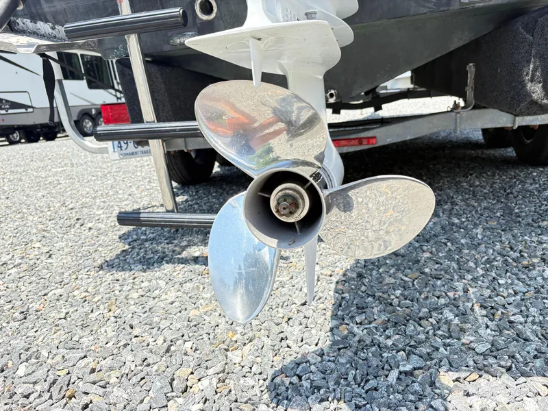 Slide: The Image of Propeller of 2022 Aquasport 2300 CC boat on gravel surface. - 10