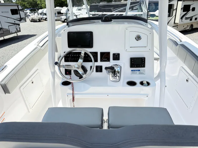 Slide: The Image of 2022 Aquasport 2300 CC boat console with steering wheel and controls. - 13