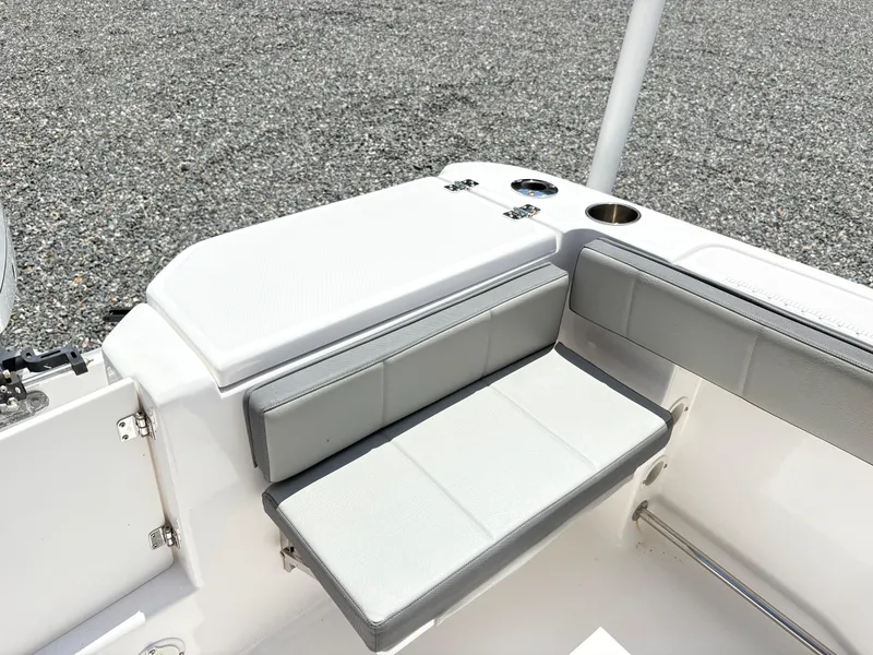 Slide: The Image of 2022 Aquasport 2300 CC boat seating area with gray cushions and cup holders. - 14