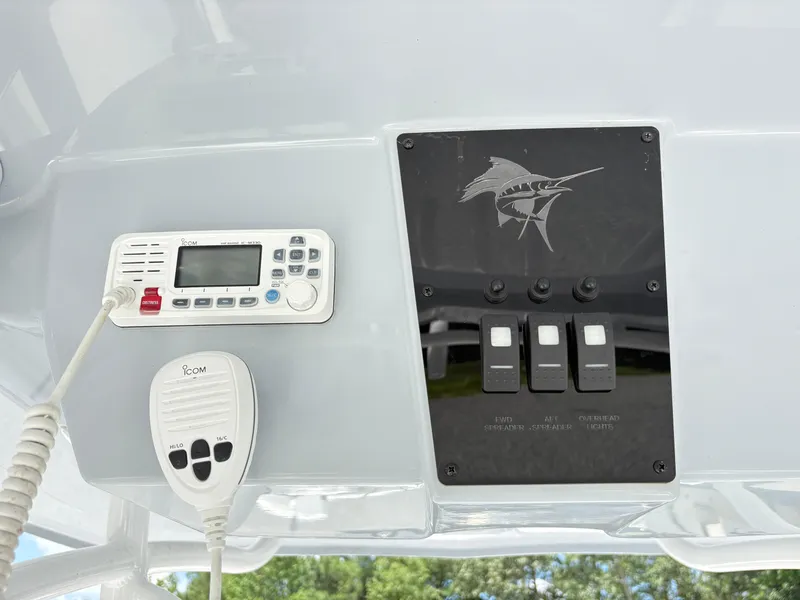 Slide: The Image of Control panel of 2022 Aquasport 2300 CC boat with radio and switches. - 17