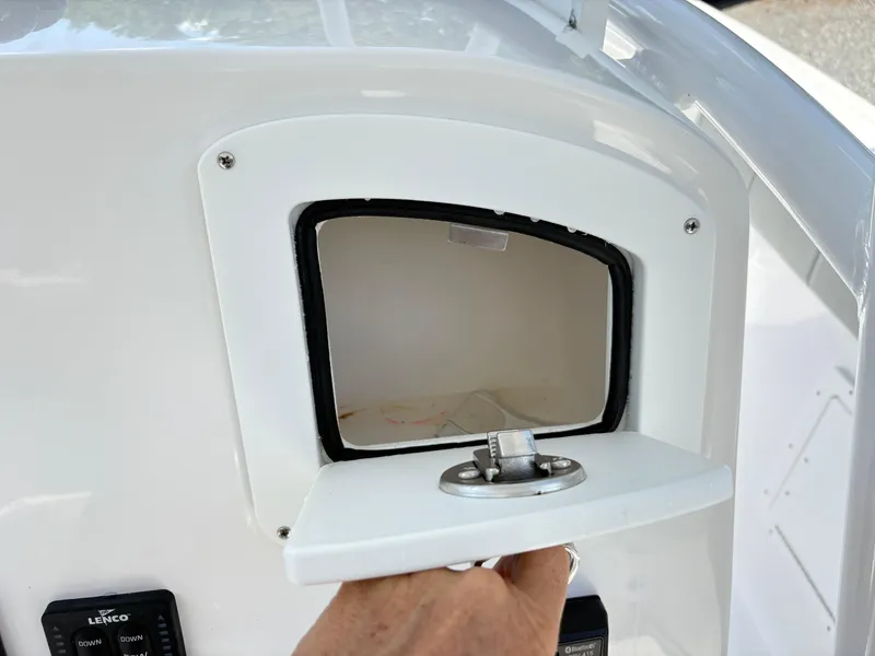 Slide: The Image of Open storage compartment on 2022 Aquasport 2300 CC boat. - 18