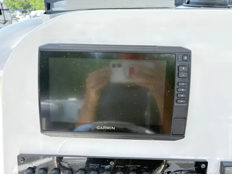 Slide: The Image of Garmin display on 2022 Aquasport 2300 CC boat dashboard with control panel. - 19