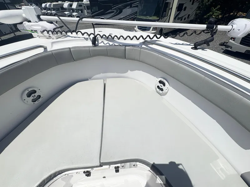 Slide: The Image of 2022 Aquasport 2300 CC boat interior with cushioned seating and mounted equipment. - 22