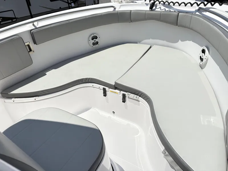 Slide: The Image of 2022 Aquasport 2300 CC boat interior with cushioned seating area. - 25