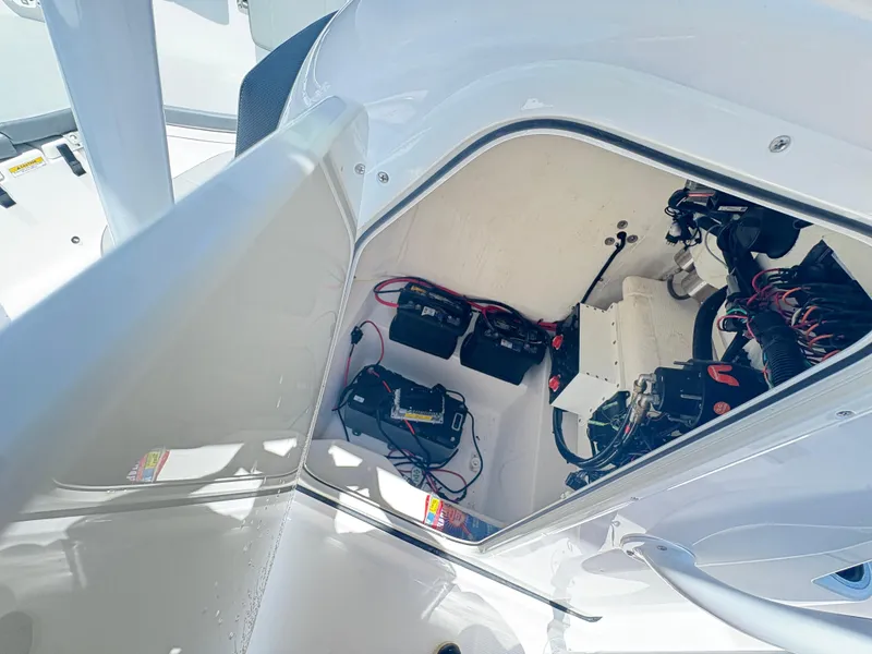Slide: The Image of 2022 Aquasport 2300 CC boat compartment with batteries and wiring. - 29