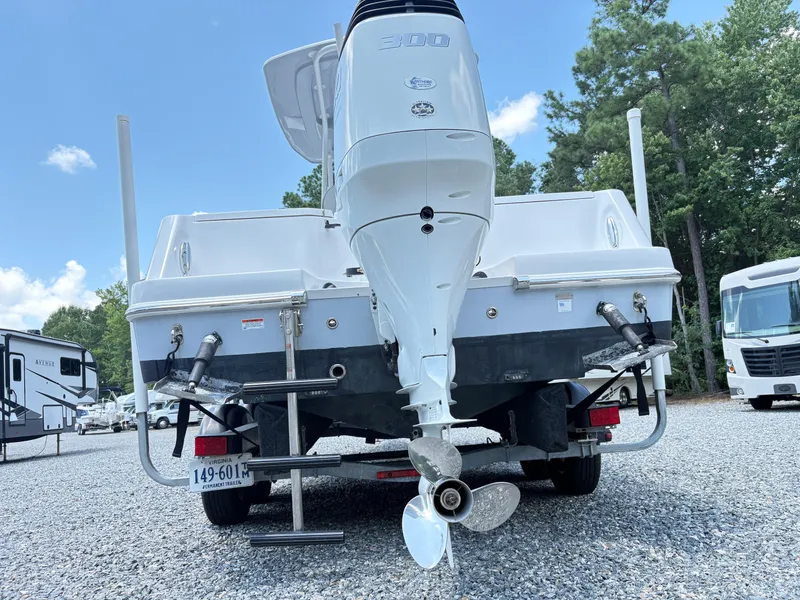 Slide: The Image of 2022 Aquasport 2300 CC boat rear view with outboard motor and trailer. - 3