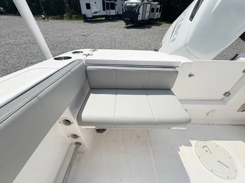 Slide: The Image of 2022 Aquasport 2300 CC boat interior with gray seating and cup holders. - 35