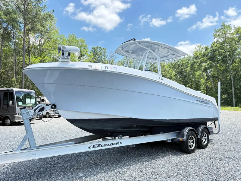 Slide: The Image of 2022 Aquasport 2300 CC boat on EZ Loader trailer, parked outdoors under blue sky. - 5