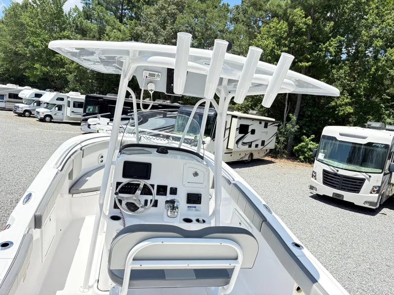 Slide: The Image of 2022 Aquasport 2300 CC boat with center console, parked near RVs in a lot. - 8