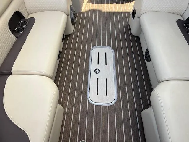 Slide: The Image of Interior of 2022 Premier 250 Sunsation boat with striped flooring and cushioned seating. - 13
