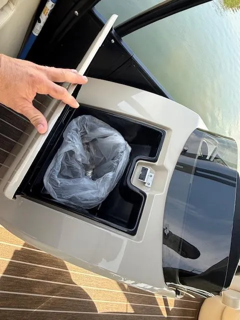 Slide: The Image of 2022 Premier 250 Sunsation boat with built-in trash compartment and cover. - 18