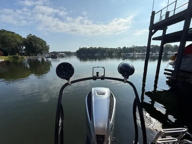 Slide: The Image of 2022 Premier 250 Sunsation boat on a calm lake with clear skies and surrounding trees. - 33