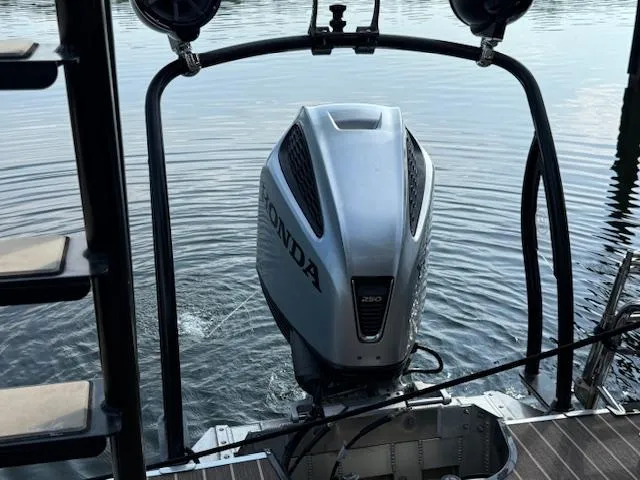 Slide: The Image of 2022 Premier 250 Sunsation with Honda 250 outboard motor on calm water. - 34