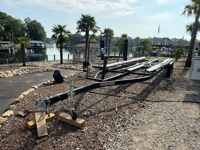 Slide: The Image of Empty boat trailer near a scenic lakeside with palm trees, 2022 Premier 250 Sunsation. - 39